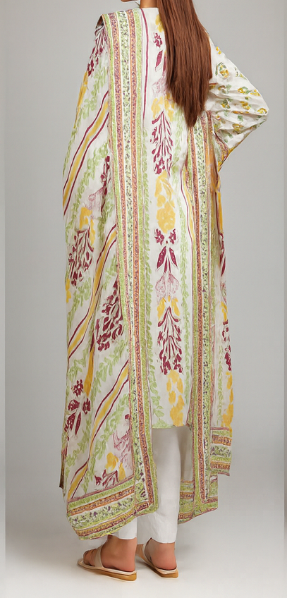 Woman wearing a long, patterned dress with a neutral background