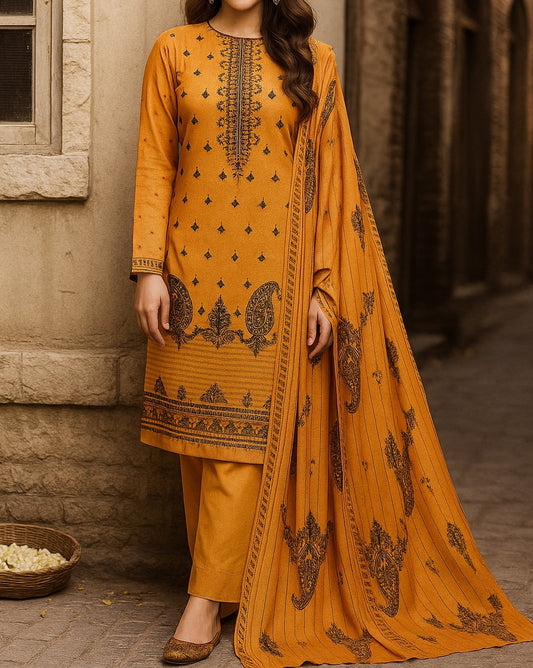Woman wearing a mustard yellow traditional outfit with black embroidery against a stone wall.