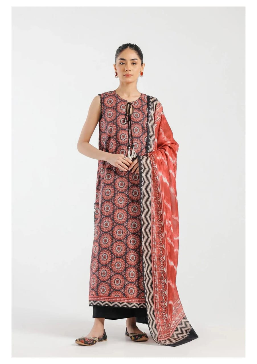 Woman wearing a patterned kurta with a matching dupatta on a white background