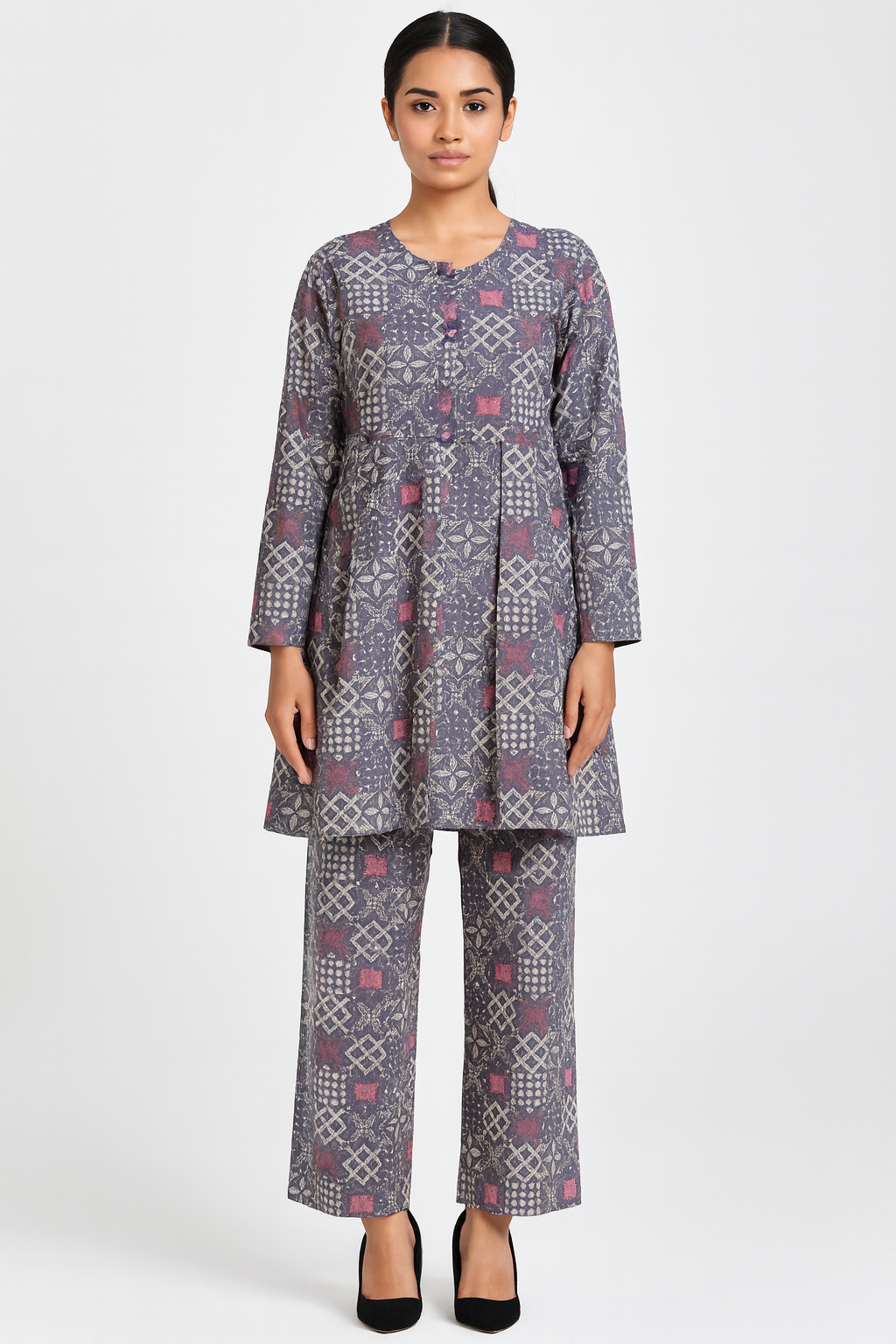 Woman wearing a patterned outfit on a white background