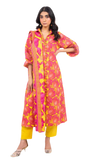 Woman wearing a pink and yellow patterned kurta with yellow pants on a white background