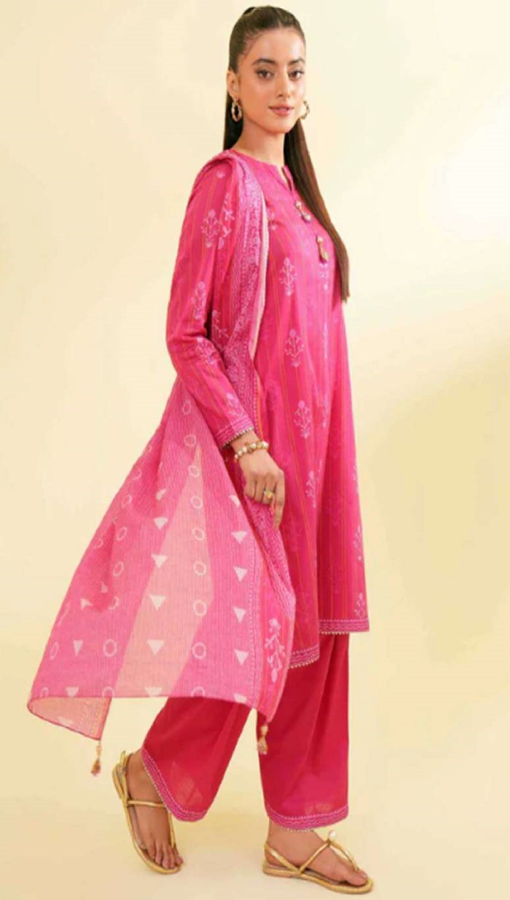 Woman wearing a pink traditional outfit with a sheer dupatta on a beige background