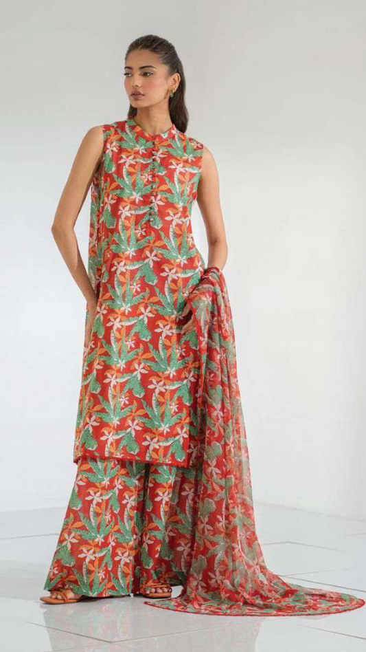 Woman wearing a red and green floral dress on a white background