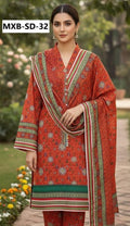 Woman wearing a red patterned outfit with a matching dupatta in an outdoor setting.