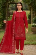 Woman wearing a red traditional outfit with embroidery outdoors.