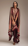 Woman wearing a sobia nazir printed outfit with a matching dupatta on a beige background