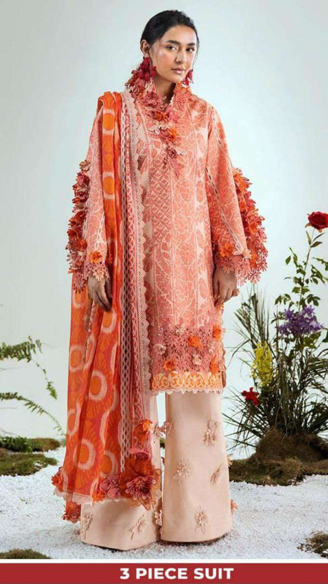 Woman wearing a three-piece suit with floral patterns against a white background