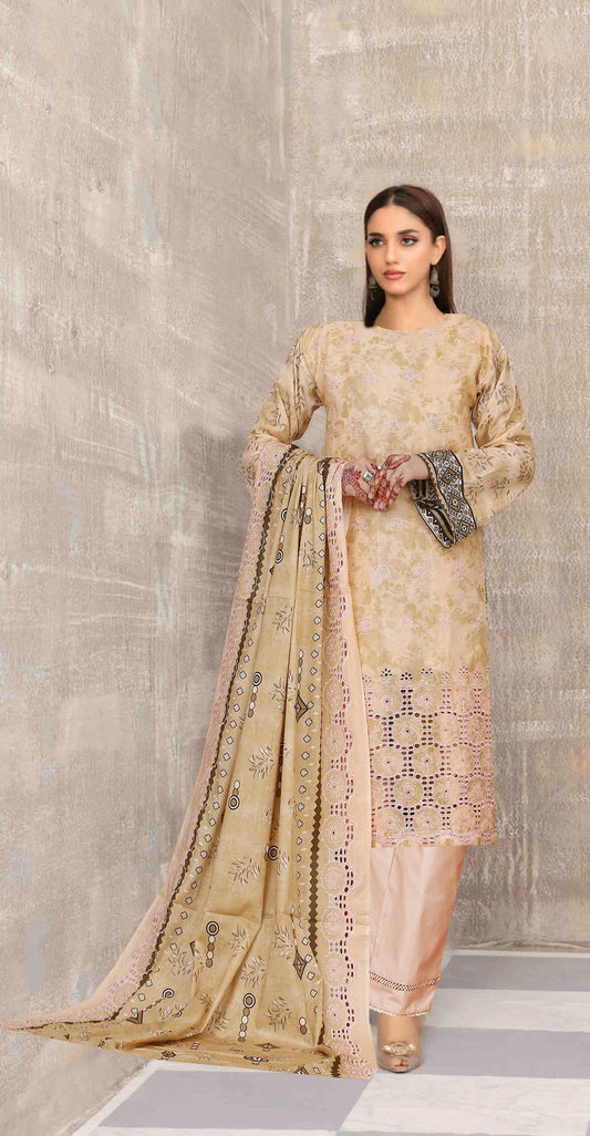 Woman wearing a traditional outfit with a beige and pink patterned dress against a gray wall.