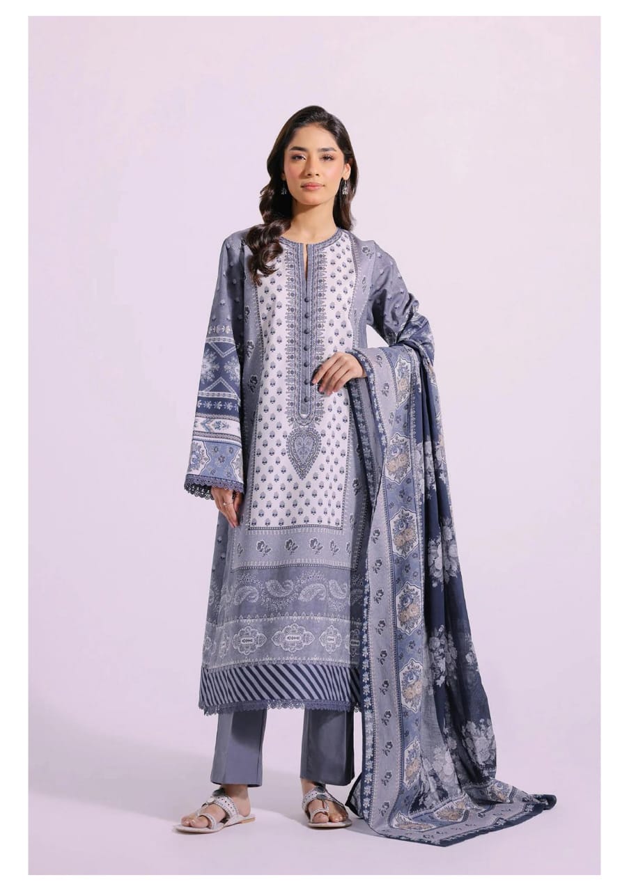 Woman wearing a traditional outfit with a matching dupatta on a light pink background