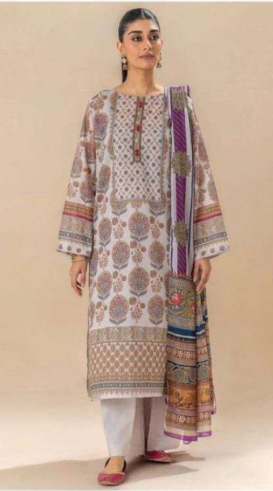 Woman wearing a traditional outfit with a patterned shirt and dupatta on a beige background
