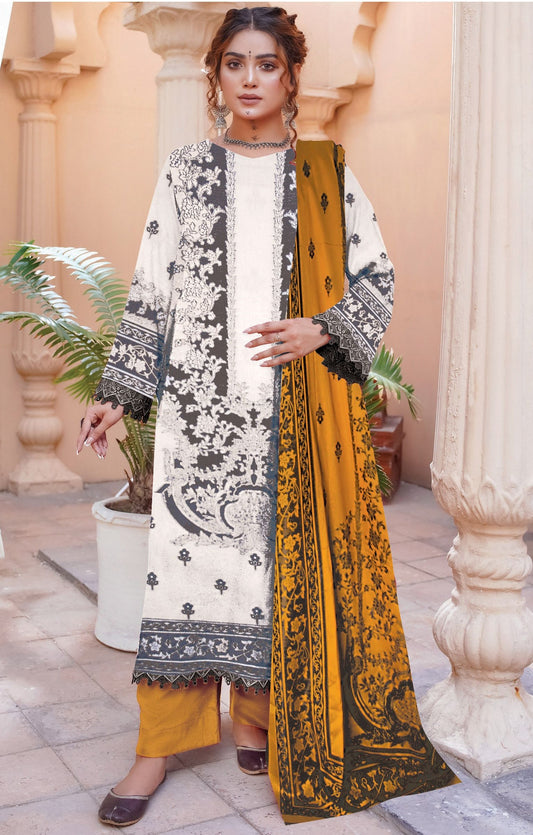 Woman wearing a traditional outfit with a white and black patterned shirt and yellow pants, standing in an outdoor setting.