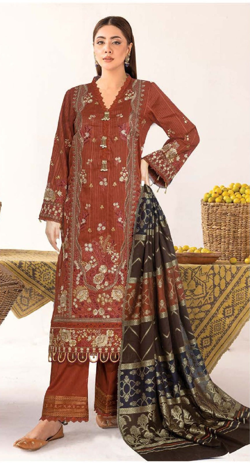 Woman wearing a traditional outfit with intricate patterns on a white background