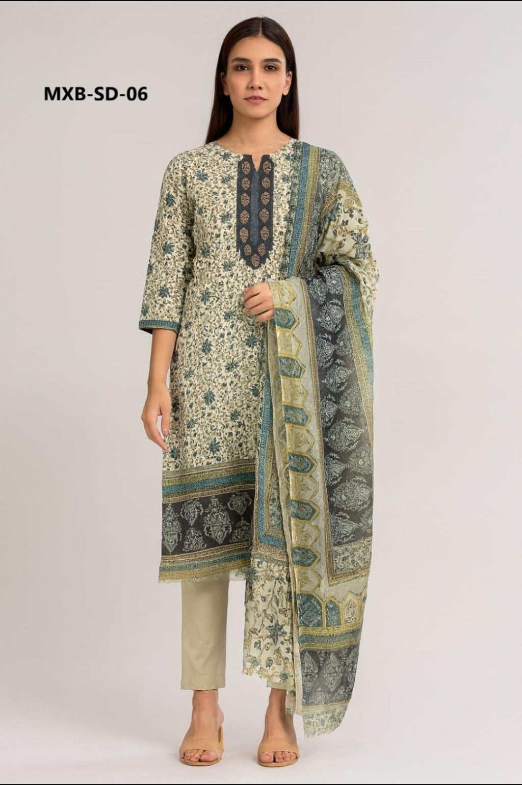 Woman wearing a traditional outfit with a floral design on a plain background