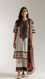 Woman wearing a traditional printed outfit with a white background