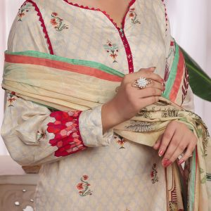 Woman wearing a traditional printed suit with a ring on her finger.