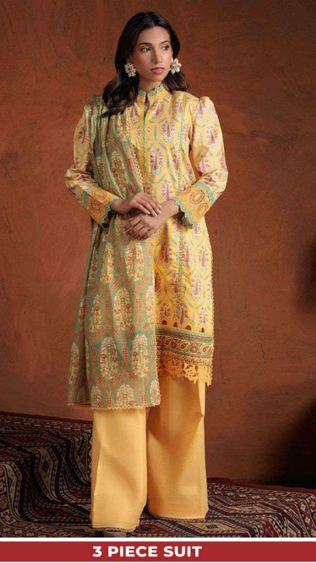 Woman wearing a yellow and green patterned suit with a brown background