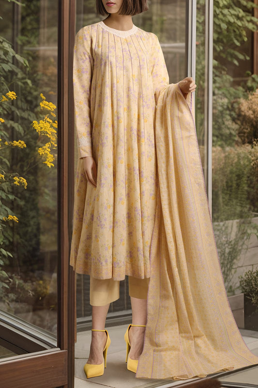 Woman wearing a yellow dress with a matching dupatta in a room with large windows.