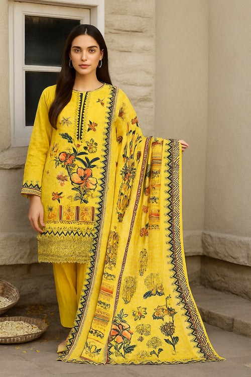 Woman wearing a yellow embroidered outfit with a matching dupatta outdoors.