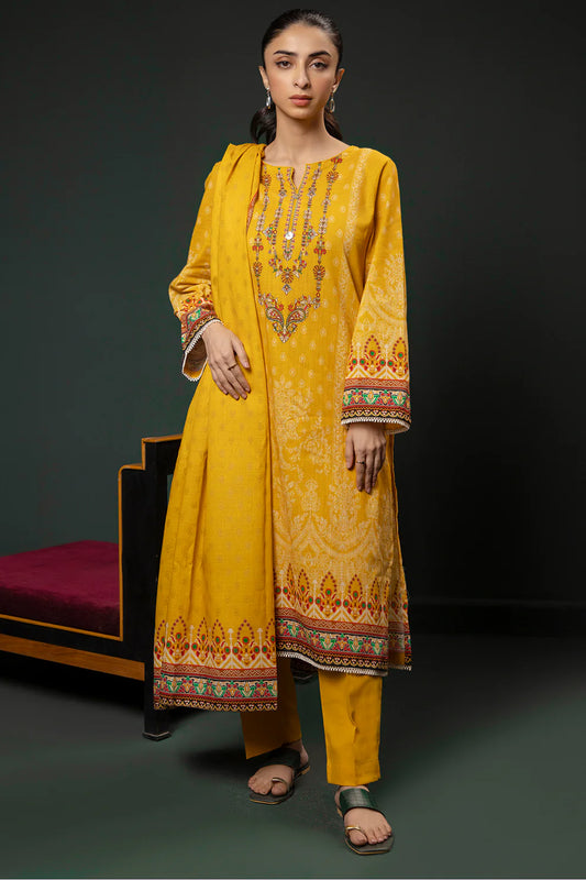 Woman wearing a yellow embroidered traditional outfit on a dark background
