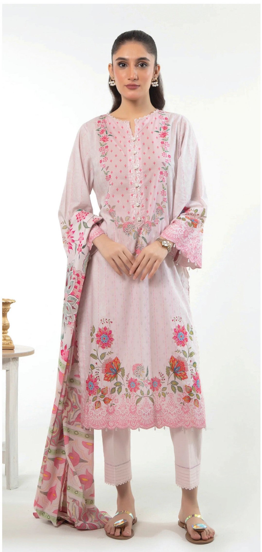 Woman wearing a pink floral outfit on a white background