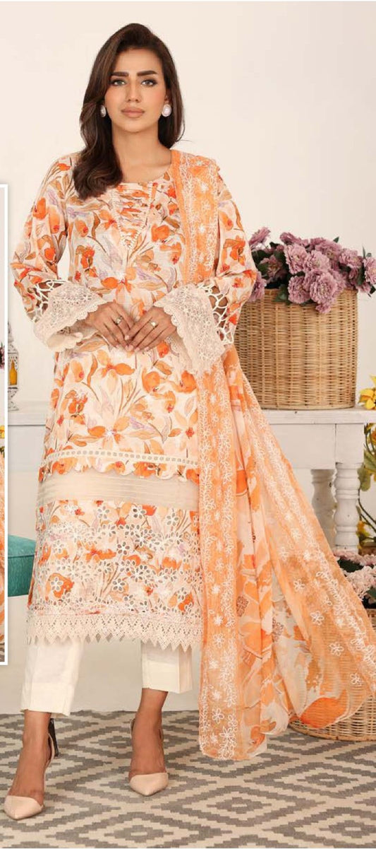 Woman wearing an orange and white floral dress with a matching dupatta in a decorated room.