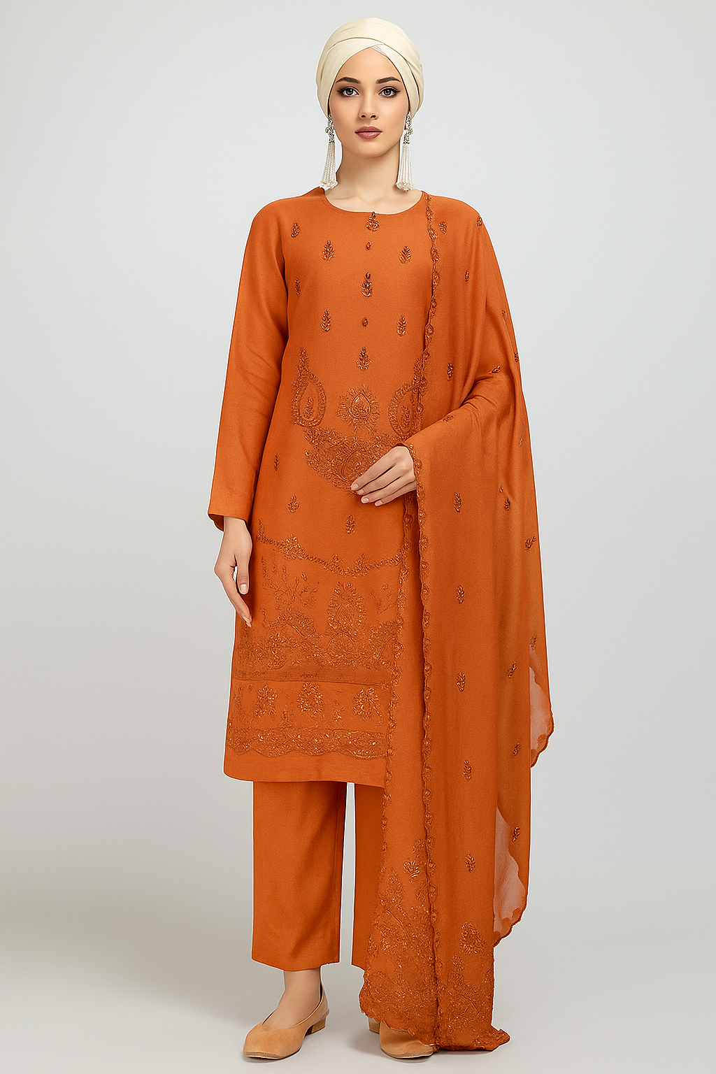 Woman wearing an orange traditional outfit with a matching dupatta on a white background
