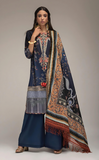 Woman wearing sobia_nazir a traditional outfit with a dark blue printed dress and patterned dupatta on a neutral background