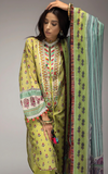 Woman wearing  sobia_nazir a yellow traditional outfit with a green dupatta against a gray background