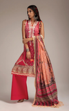 Woman wearing  sobia_nazir traditional outfit with a pink and red dress and patterned dupatta on a neutral background