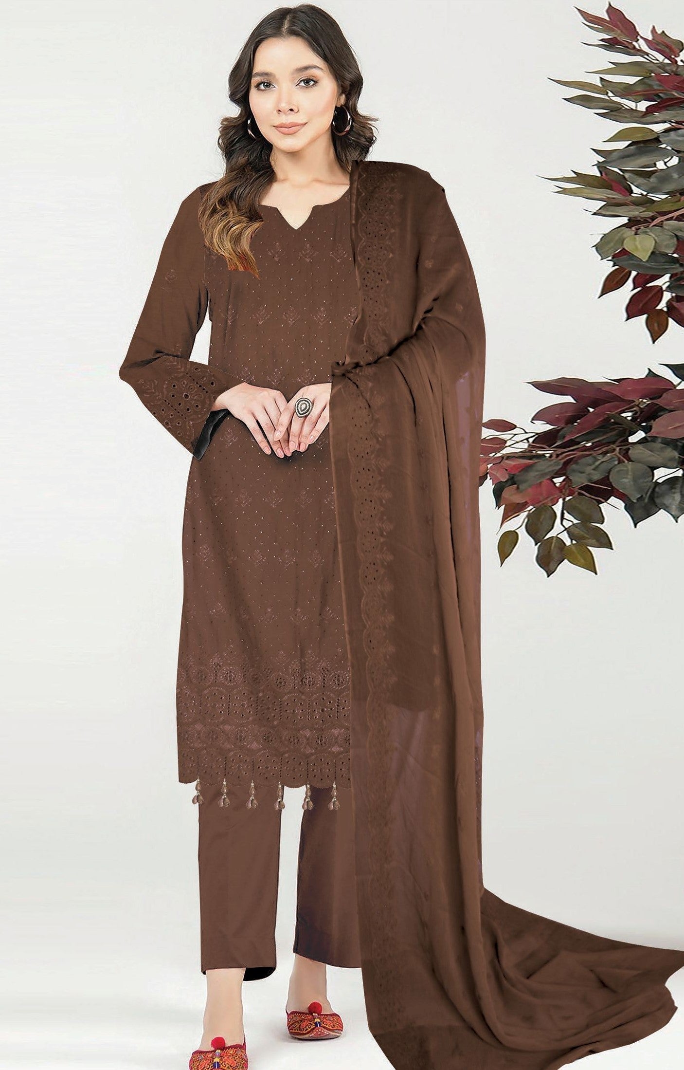 Woman wearing a brown traditional outfit with a scarf against a white background