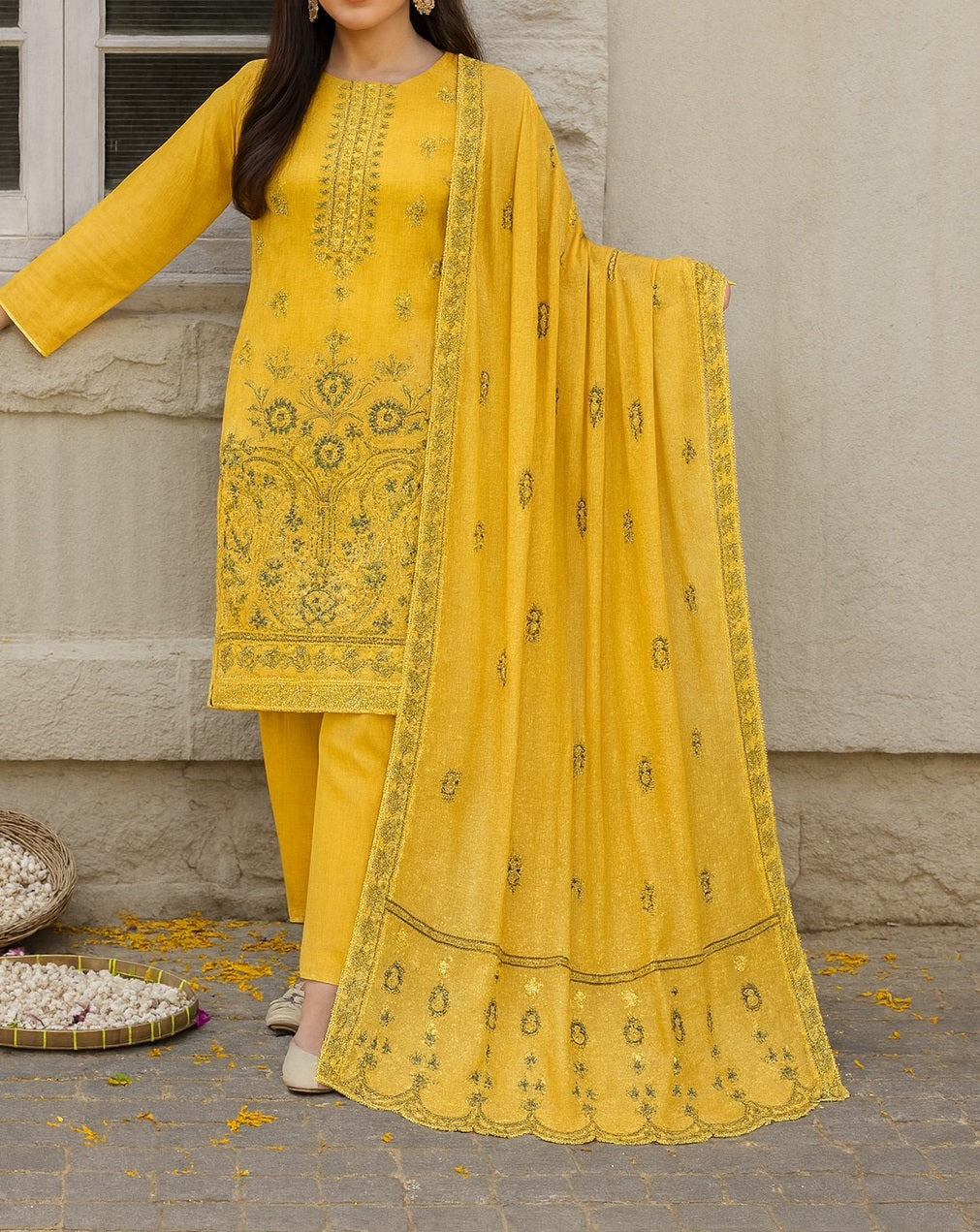Yellow embroidered traditional outfit with dupatta against a neutral background