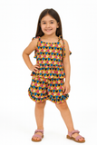 Young girl wearing a colorful dress with heart patterns on a white background