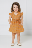 Young girl wearing an orange and yellow striped dress on a white background