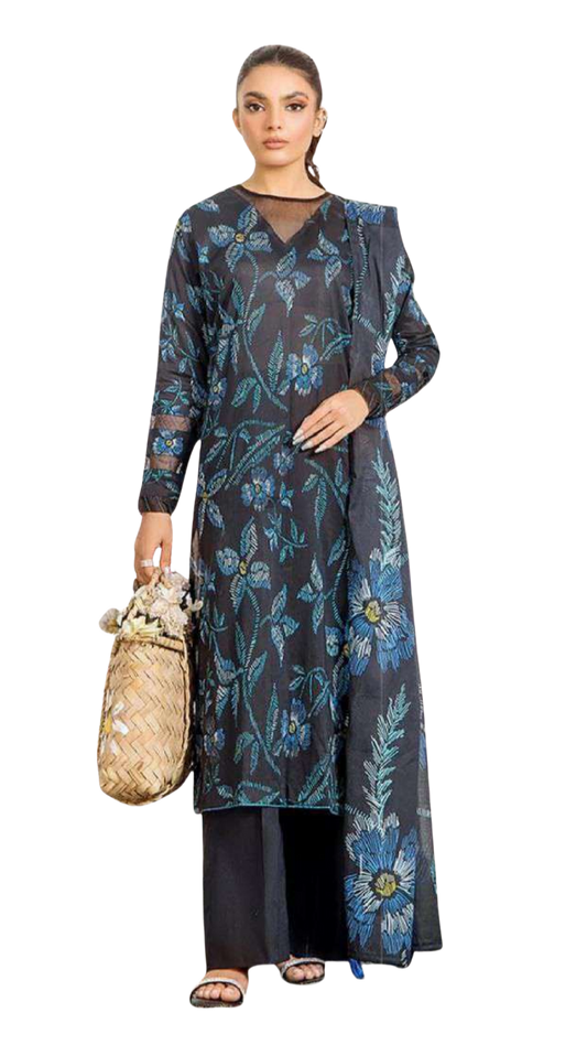 Woman wearing a long dark dress with blue floral patterns on a white background
