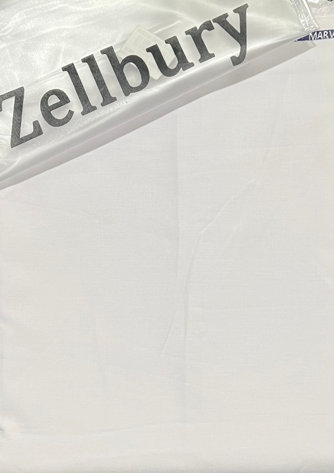 Zellbury logo on a white suit background