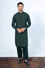 Man wearing a dark green kurta with trouser on a white background