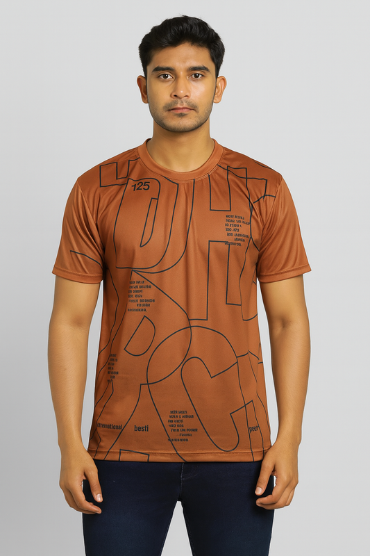 Man wearing a mastard t-shirt with black geometric patterns on a light gray background