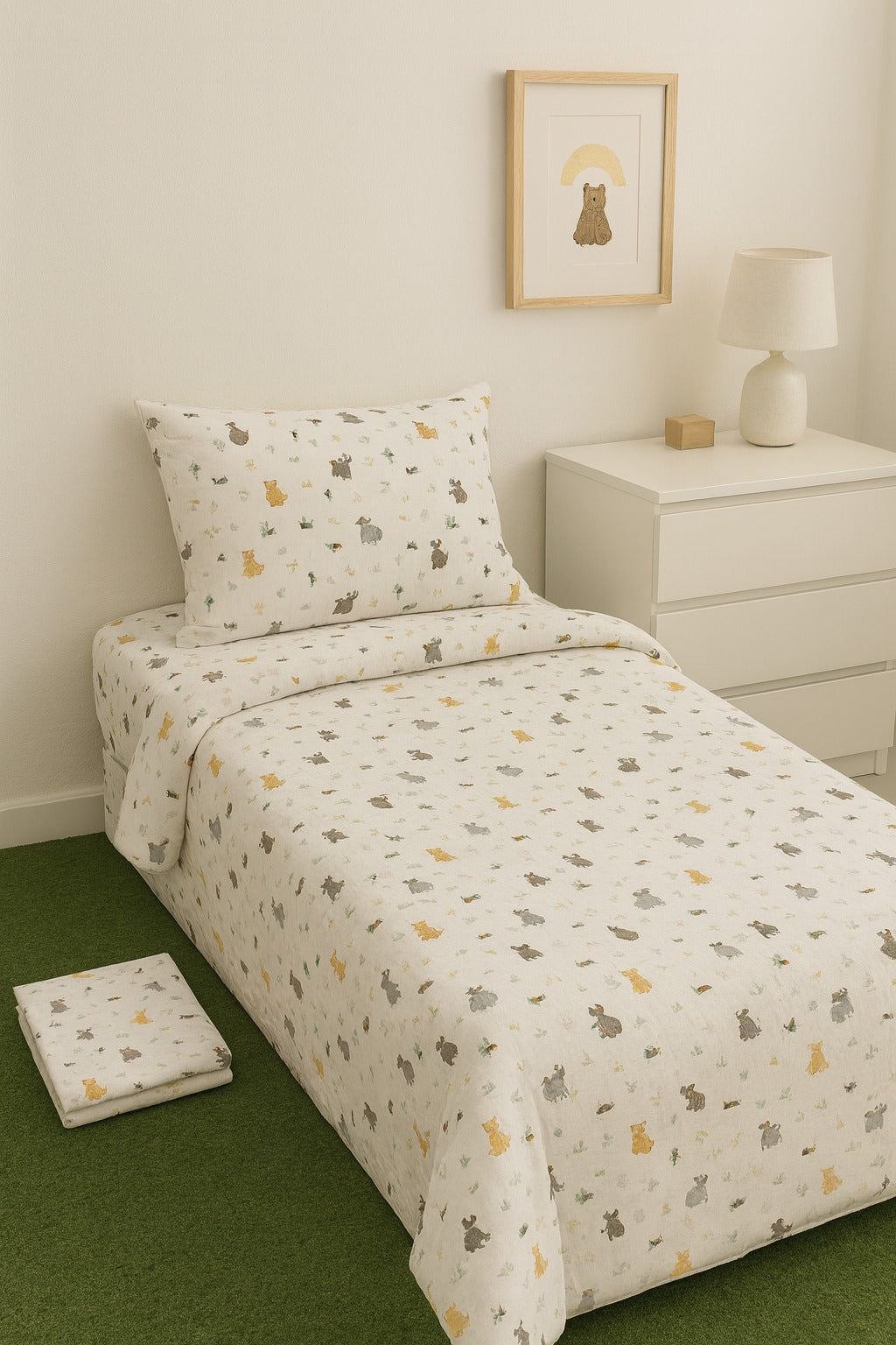 Bedding set with animal pattern on a bed in a room with a nightstand and lamp.