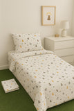 Bedding set with animal pattern on a bed in a room with a nightstand and lamp.