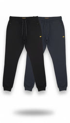 Two pairs of black jogger pants with yellow accents on a white background