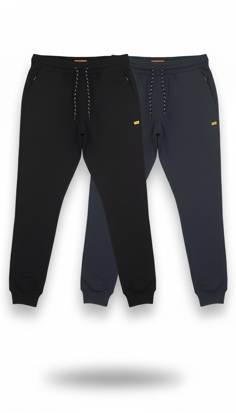 Two pairs of black jogger pants with yellow accents on a white background