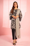 Woman wearing a black and white patterned outfit with a pink background