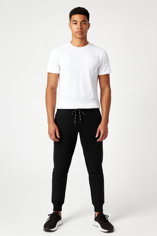 Person wearing a white t-shirt and black pants on a white background