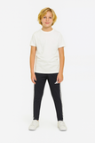 Child wearing a white t-shirt and black pants with a brand logo on a white background