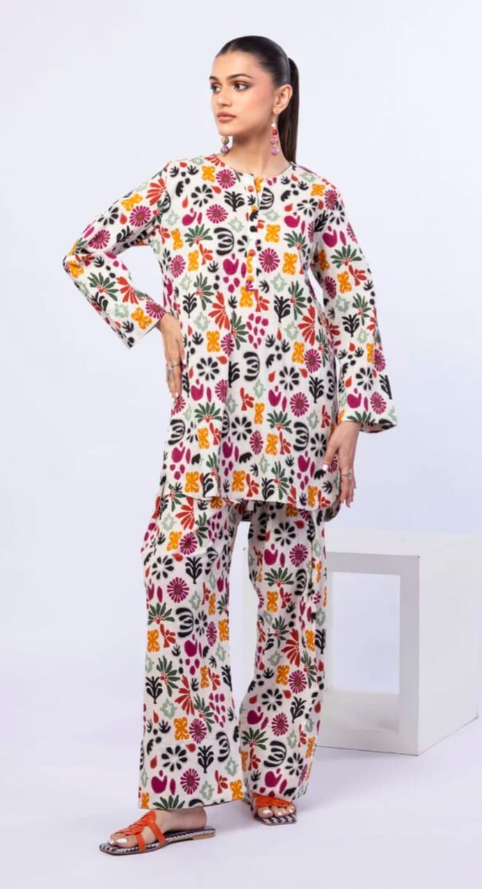 Woman wearing a colorful floral outfit on a white background