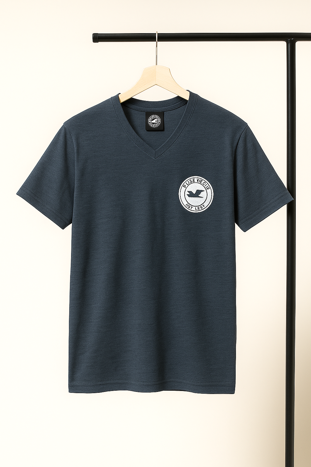 dark gray blue t-shirt with a logo on a hanger against a neutral background