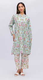 Woman wearing a floral dress and pants set on a white background