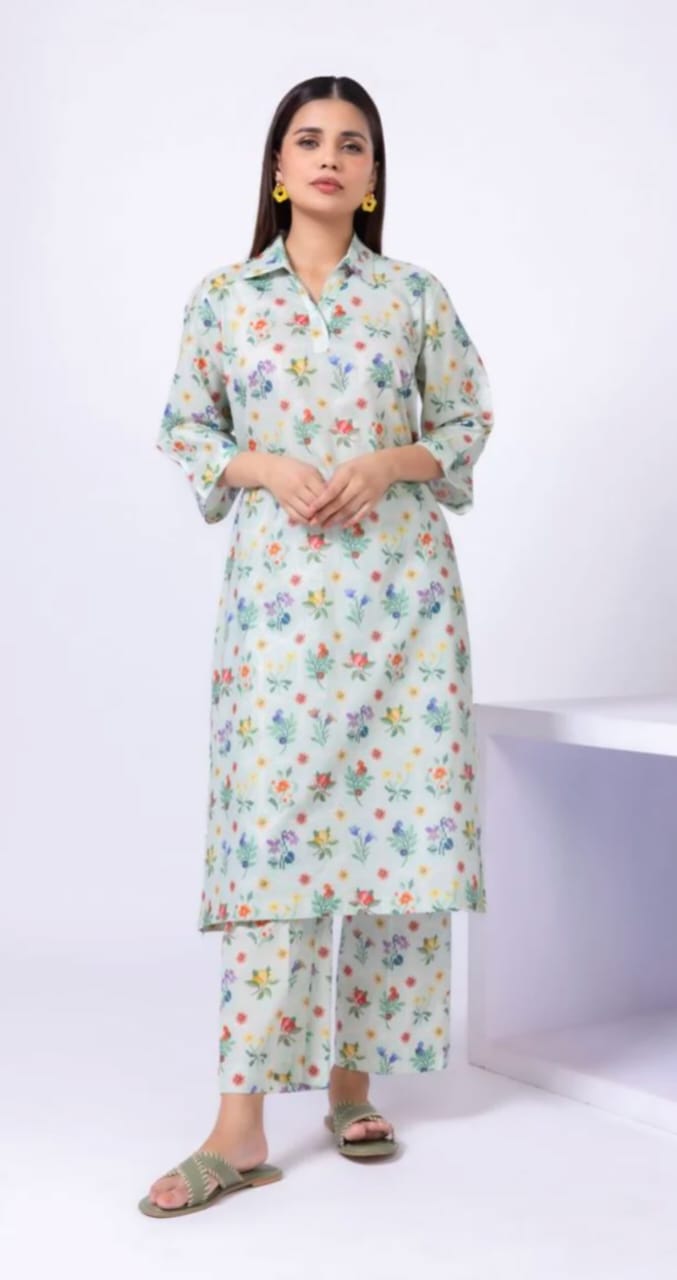 Woman wearing a floral kurta with pants on a white background