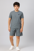 Person wearing a gray Nike t-shirt and shorts on a light gray background