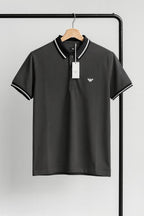 gray polo shirt with white coller on a hanger against a gray background